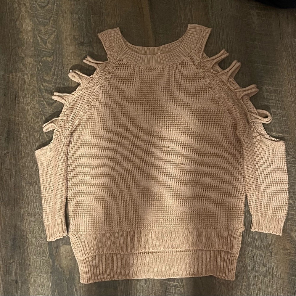 Pink sweater sleeves ripped